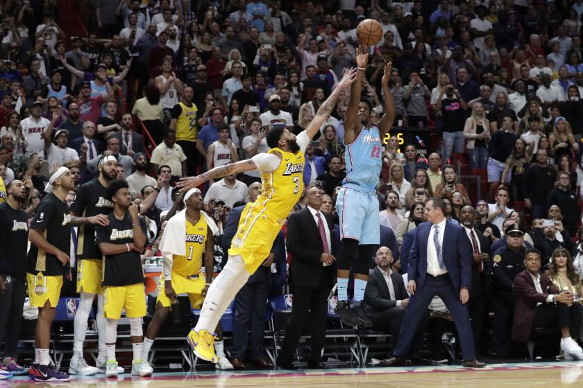 Lakers forward Anthony Davis challenges a last-second shot by Heat guard Jimmy Butler during a game Dec. 13, 2019, in Miami.