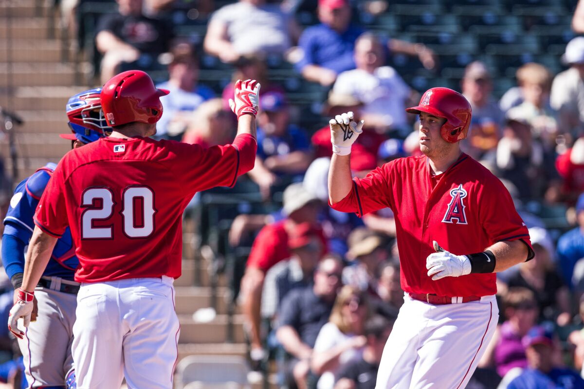 Angels outfielder Matt Joyce greets teammate C.J. Cron after Cron hit a home run in a spring training exhibition.