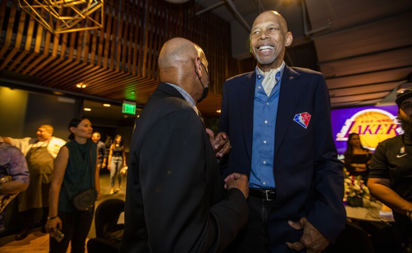 Stu Lantz, left, greets Kareem Abdul-Jabbar during birthday party in the Lakers Lounge at Crypto.com Arena.