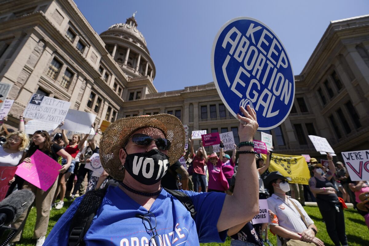 FILE-Abortion rights demonstrators attend a rally at the Texas Capitol, Saturday, May 14, 2022, in Austin, Texas. Progressive prosecutors around the U.S. are declaring they won't enforce some of the most restrictive and punitive anti-abortion laws that GOP-led states have waited years to implement. The promises come as the Supreme Court appears on track to overturn the constitutional right to abortion. (AP Photo/Eric Gay, File)