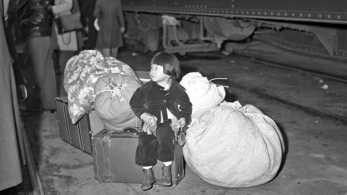 April 1, 1942: A girl waits for the train taking her and her family to Manzanar.