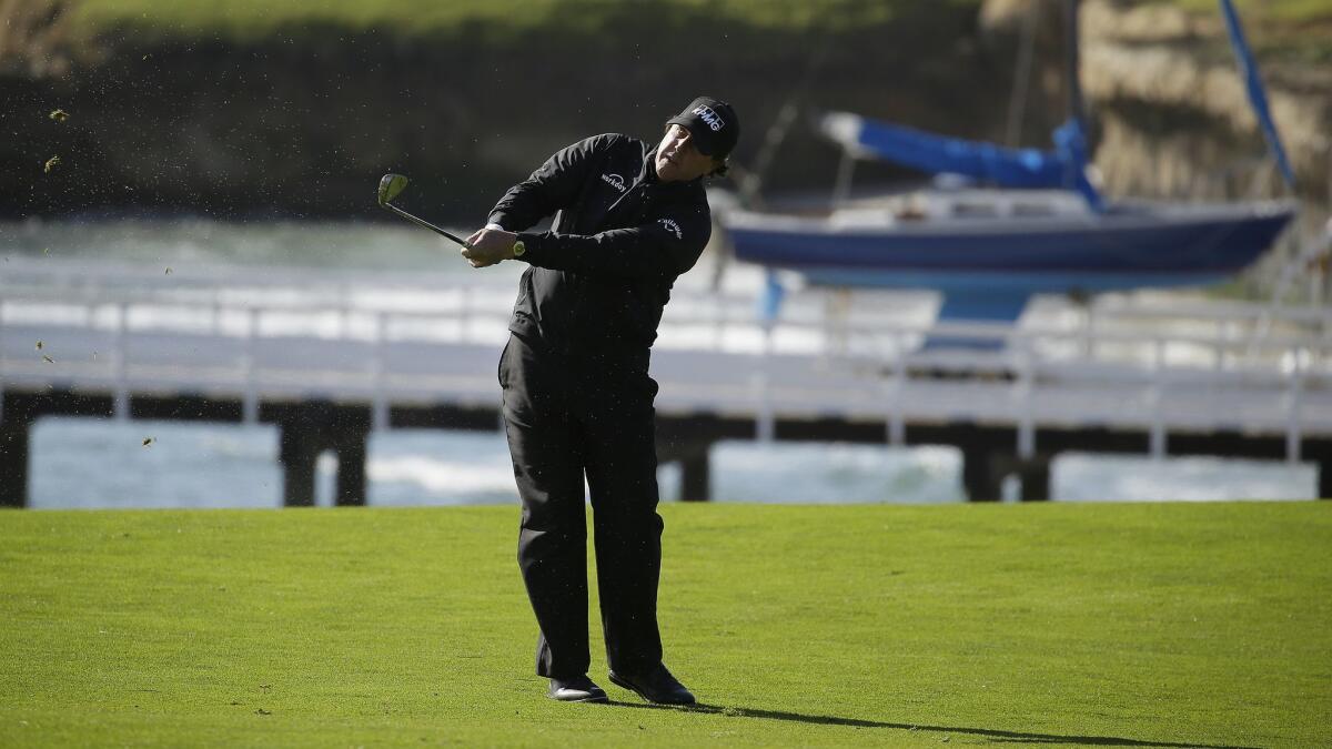 Phil Mickelson follows his approach shot from the fourth fairway during the final round of the Pebble Beach Pro-Am on Sunday.