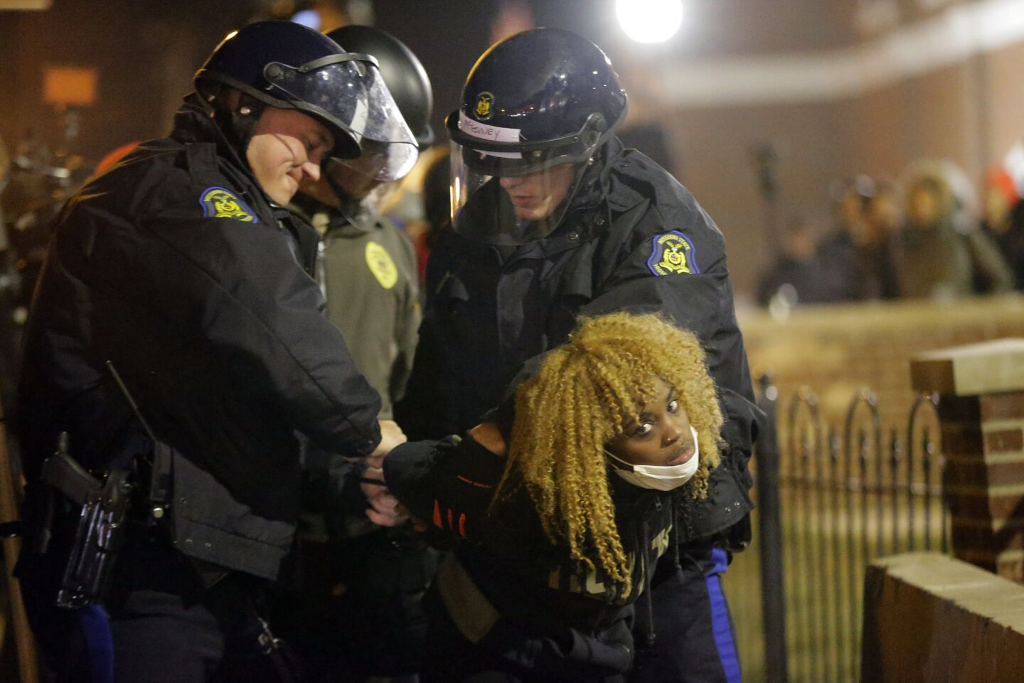 Police officers take a protester into custody in Ferguson, Mo., on Nov. 25.