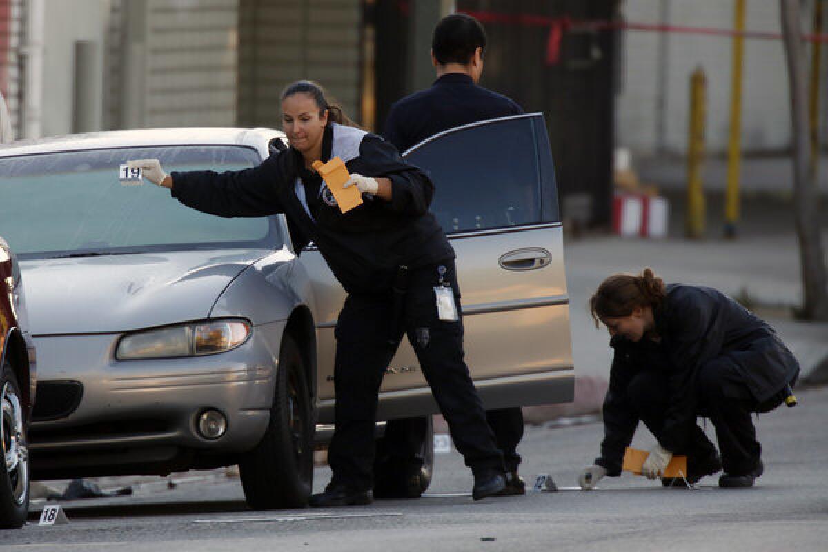 LAPD officers investigate an officer-involved shooting on Pico Boulevard just east of Bonnie Brae Street.