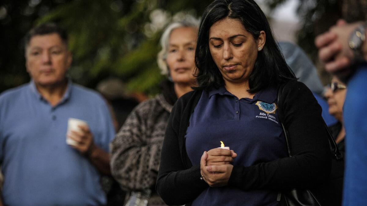 Lynwood City Councilwoman Aide Castro holds a candle at a protest against the closure of St. Francis Medical Center.