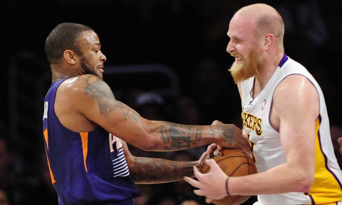 Phoenix Suns forward P.J. Tucker, left, and Lakers center Chris Kaman fight for a loose ball during the Lakers' 115-99 win at Staples Center.