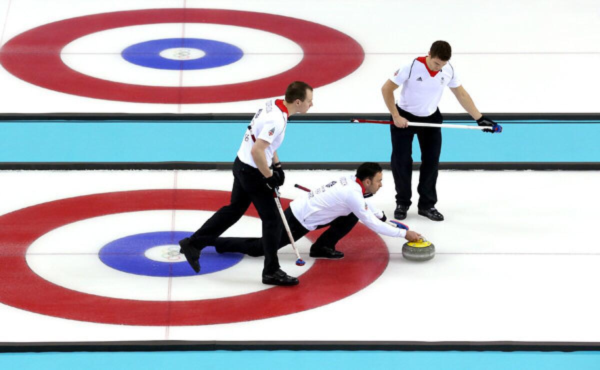 Britain's David Murdoch,center, prepares to release a stone in front of sweepers Michael Goodfellow, left, and Scott Andrews during a 6-5 win over Norway on Tuesday.