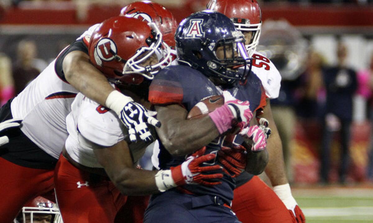 Arizona running back Ka'Deem Carey is tackled during a win over Utah last month. Stopping Carey will be a priority for the UCLA defense Saturday.
