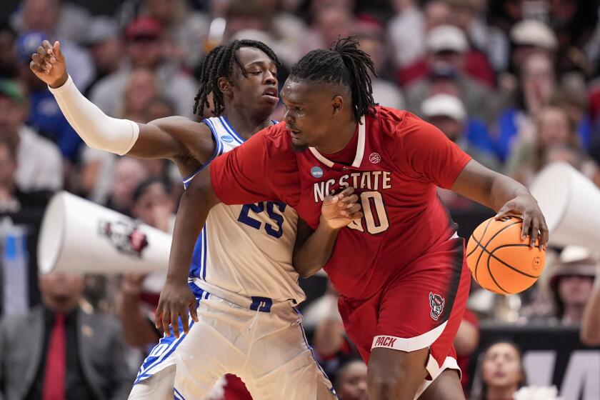 North Carolina State's DJ Burns Jr., right, works the floor against Duke's Mark Mitchell.