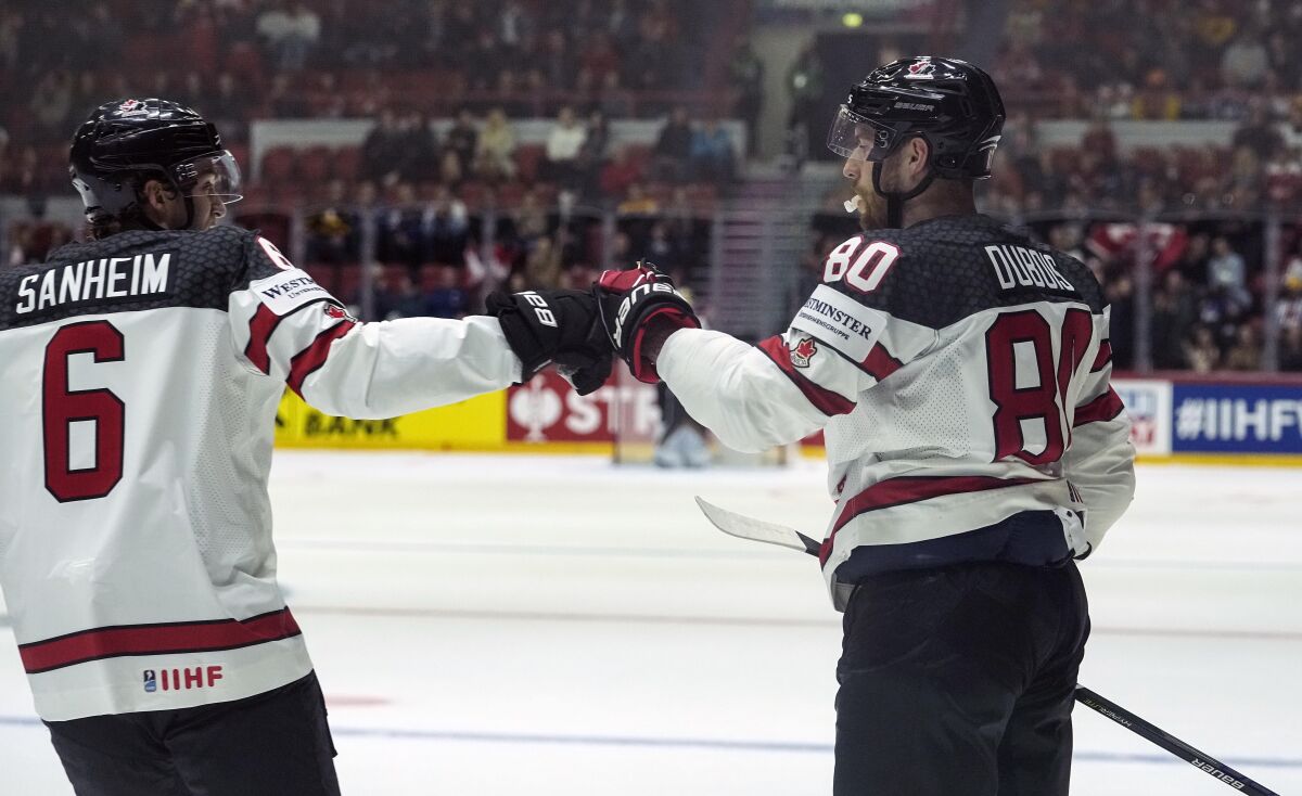 Canada's Pierre-Luc Dubois, right, celebrates after scoring his side's second goal during the group A Hockey World Championship match between Germany and Canada in Helsinki, Finland, Friday May 13, 2022. (AP Photo/Martin Meissner)