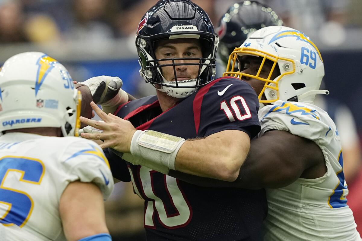 Houston Texans quarterback Davis Mills (10) is sacked by Los Angeles Chargers defensive tackle Sebastian Joseph-Day (69) during the second half of an NFL football game Sunday, Oct. 2, 2022, in Houston. (AP Photo/David J. Phillip)