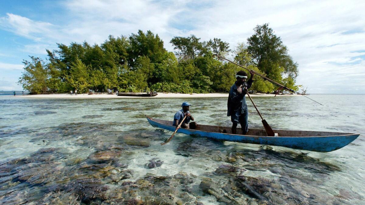 Fishermen paddle off Kennedy Island in in the remote western province of the Solomon Islands, near where John F. Kennedy's patrol boat PT-109 was rammed by a Japanese destroyer.