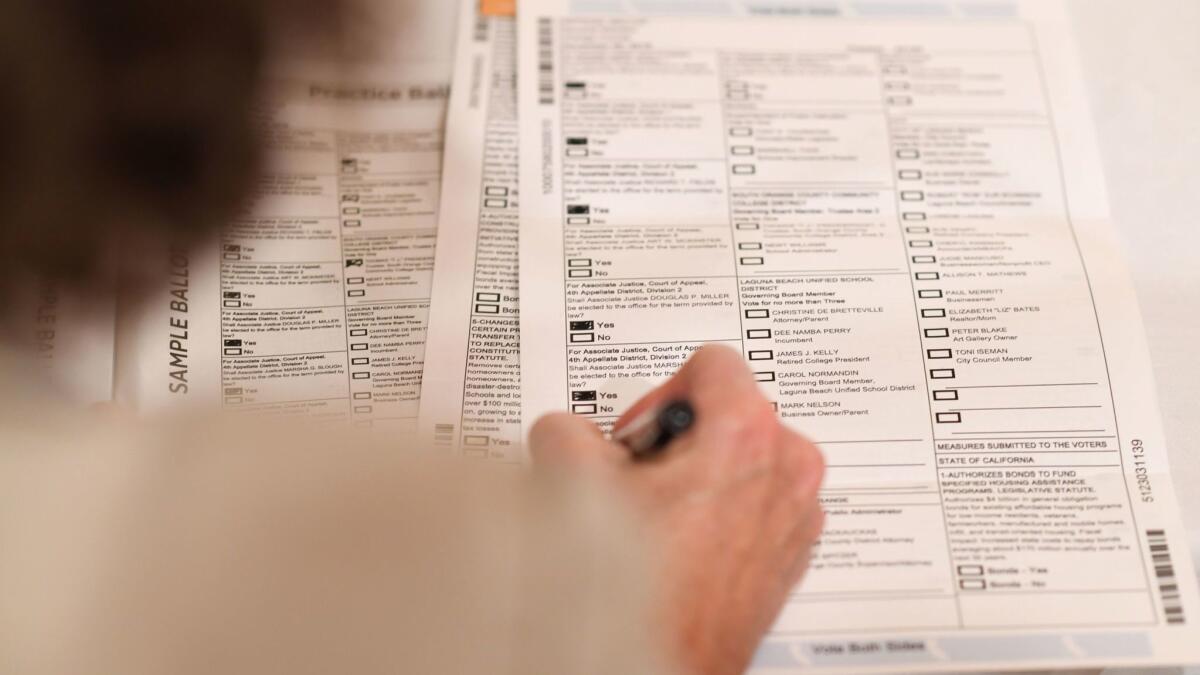 Voter Becky Visconti completes her mail-in ballot at a ballot party in Laguna Niguel last week. Voters in scores of California communities face major efforts to borrow and imposes taxes, as local governments look ahead to significant pension responsibilities.