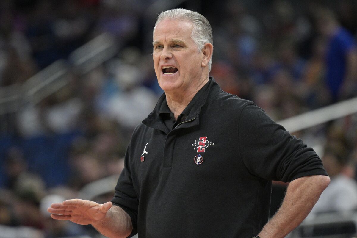 FILE - San Diego State head coach Brian Dutcher calls out instructions during the first half of a first-round college basketball game against Charleston in the NCAA Tournament on March 16, 2023, in Orlando, Fla. The number of San Diego State teams that have won an NCAA championship can be counted on one finger. Dutcher, who has been on campus for 24 years, not only knows about that championship but would love to match it when he coaches the Aztecs in their first Final Four. (AP Photo/Phelan M. Ebenhack, File)
