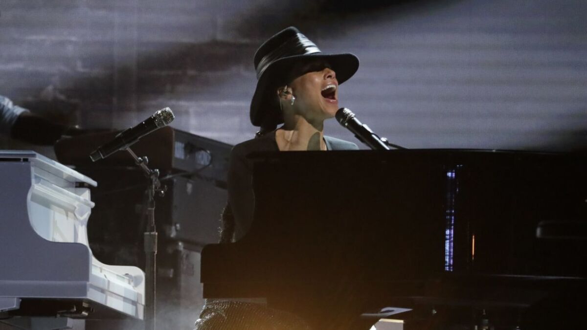 Host Alicia Keys performs on dueling pianos during the 61st Grammy Awards.