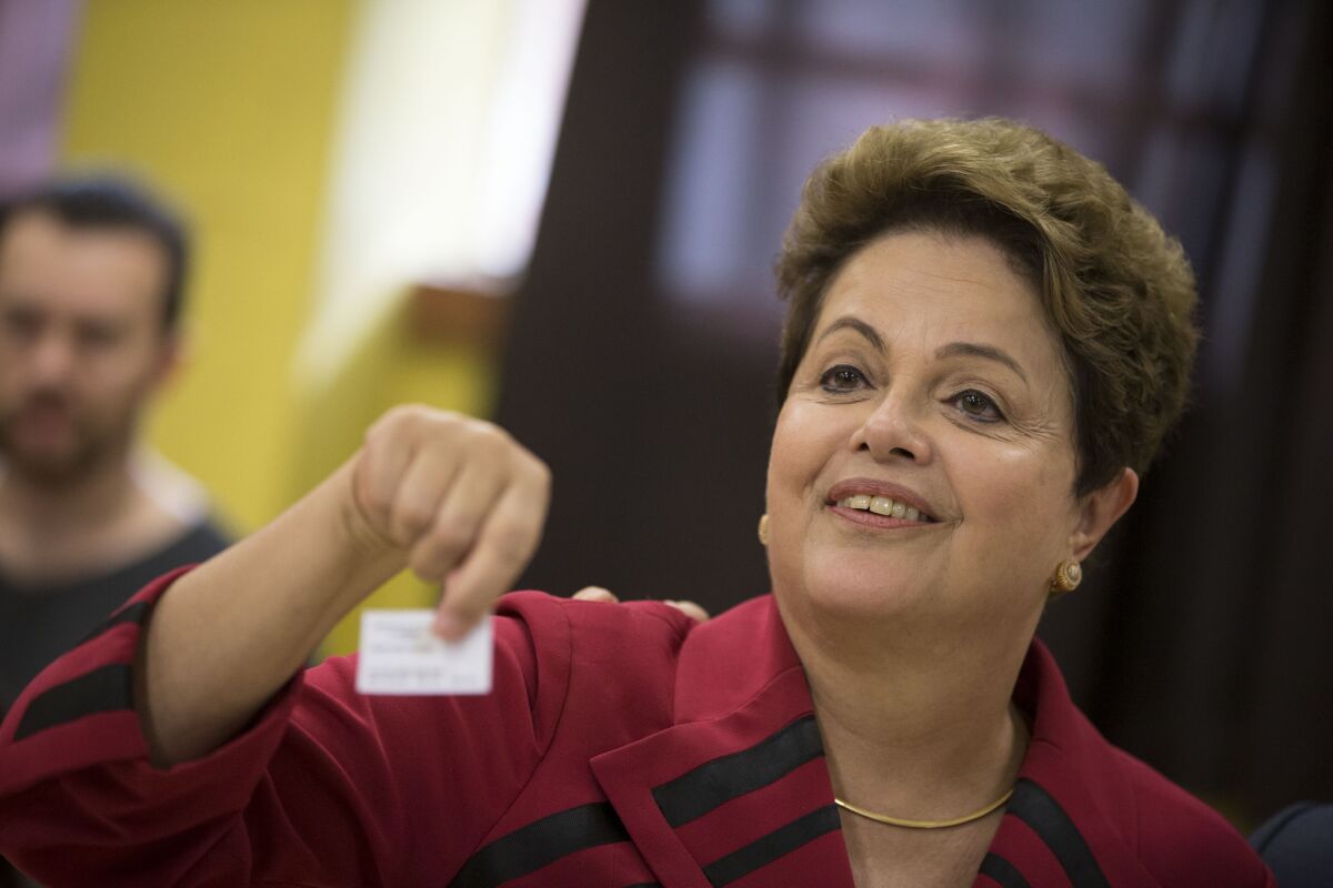 Brazilian President Dilma Rousseff, who is running for reelection, shows her electronic voting receipt after voting Sunday in Porto Alegre.