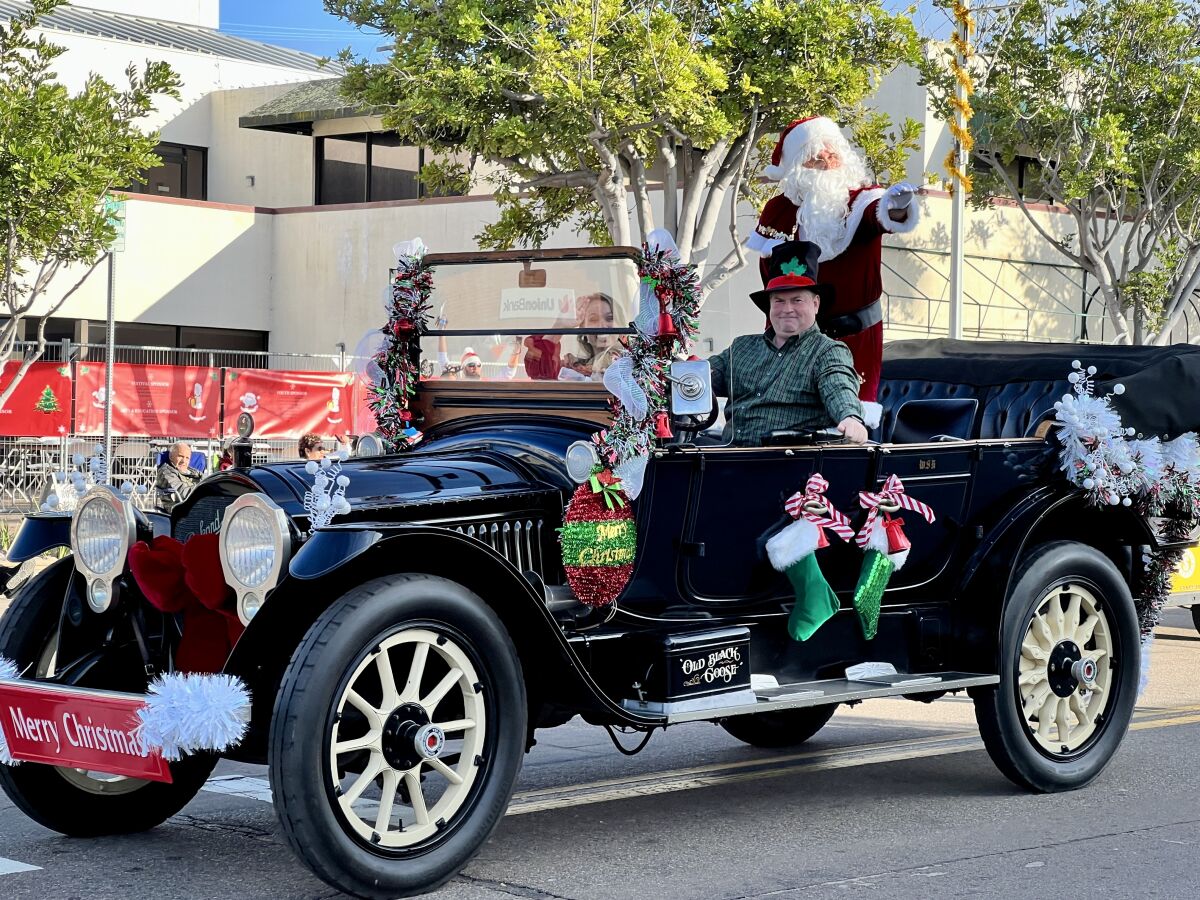 Santa Claus rides in the Old Black Goose in the 66th annual La Jolla Christmas Parade on Dec. 4.