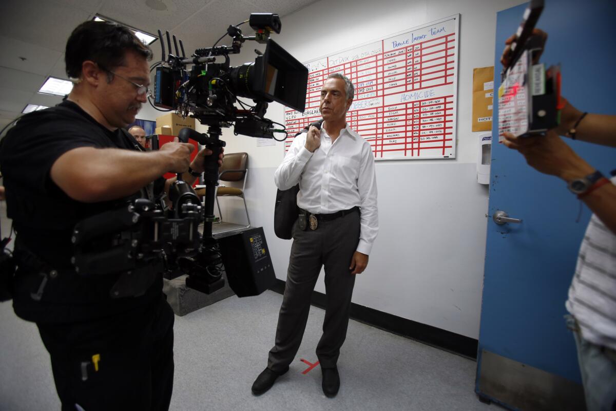 Steady cam operator Kenji Luster, left, and actor Titus Welliver, who plays Det. Harry Bosch, work on set in Hollywood. (Francine Orr / Los Angeles Times)