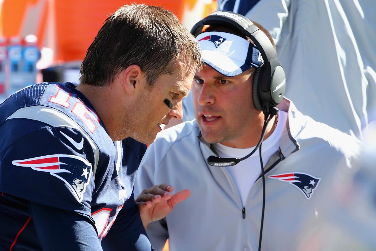 Patriots offensive coordinator Josh McDaniels, shown talking to quarterback Tom Brady, is being interviewed by multiple teams about head coaching positions this weekend.