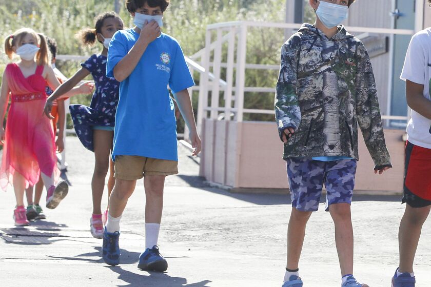 Children go back to the classroom after an outside break at Chase Avenue Elementary School during the Cajon Valley Union School District's Emergency Child Care Program on May 5, 2020 in El Cajon, California. The district is offering free child care to essential workers.