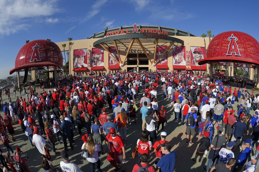 FILE - In this Monday, April 4, 2016 file photo, Fans line up outside Angel Stadium of Anaheim for an opening day baseball game between the Los Angeles Angels and the Chicago Cubs in Los Angeles. The Los Angeles Angels have opted out of their Angel Stadium lease with the city of Anaheim. The Angels informed the city of their decision Tuesday, Oct. 16, 2018. (AP Photo/Mark J. Terrill, File)