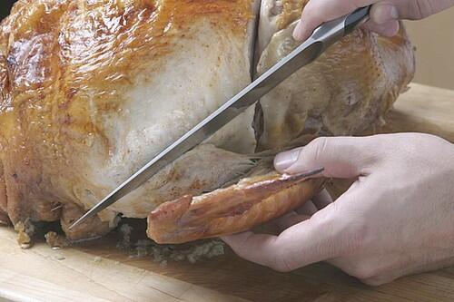 Start with the wings: Hold the knife at the joint at a 45-degree angle to the wing and slice through the joint.