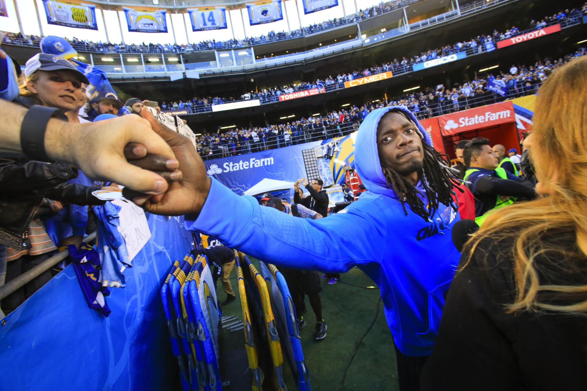 Chargers running back Melvin Gordon shakes hands with a fan at the end of the game.