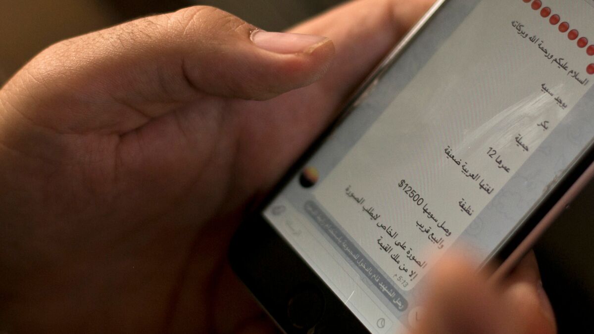 An activist in northern Iraq looks at an Islamic State group marketplace on the encrypted app Telegram, advertising a 12-year-old Yazidi girl as a slave for the price of $12,500 in May.