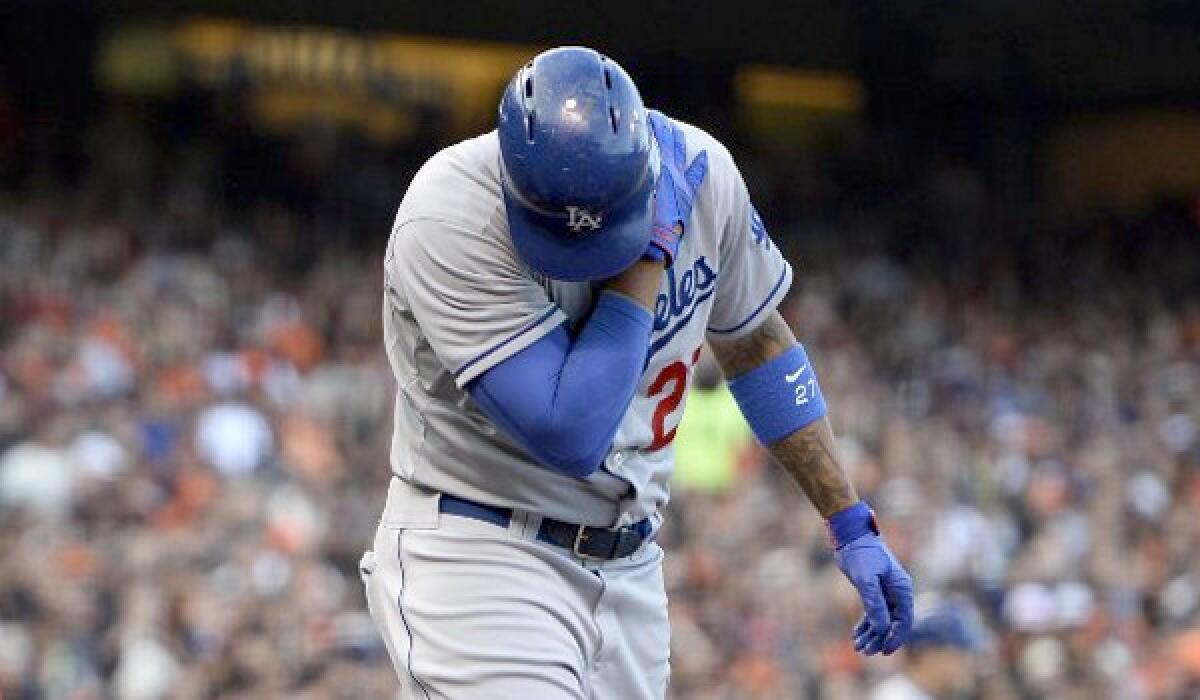 Dodgers center fielder Matt Kemp grabs at his left shoulder after his first plate appearance during the second inning of L.A.'s matchup with the San Francsico Giants.