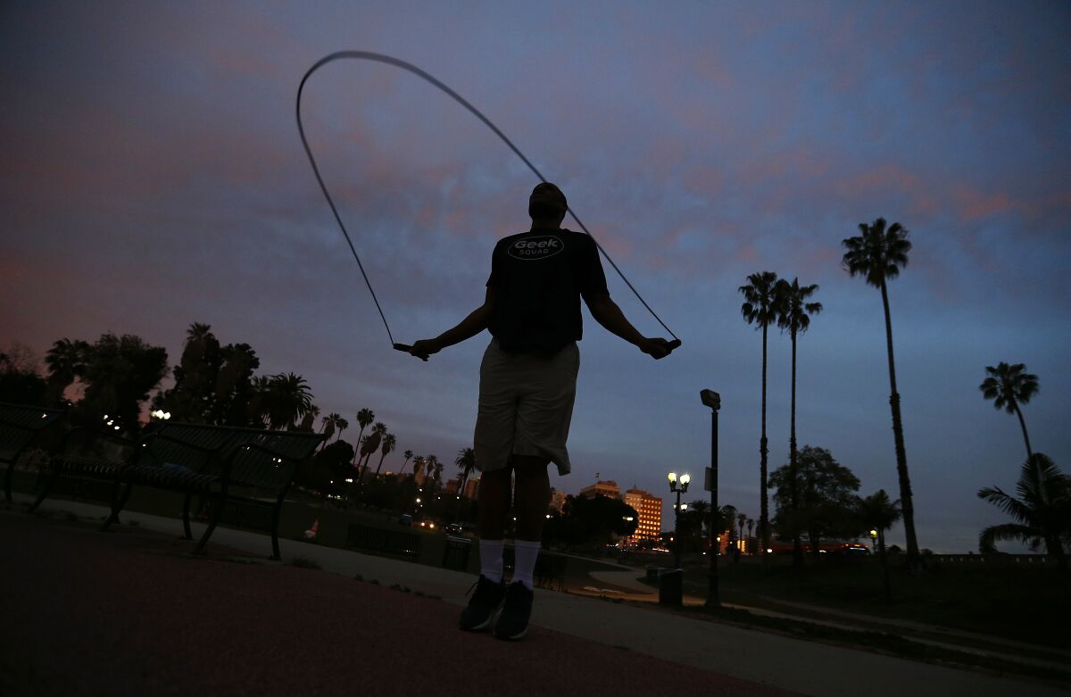 Henry Brown, 42, exercises in MacArthur Park in the Westlake District of L.A. on March 31. 