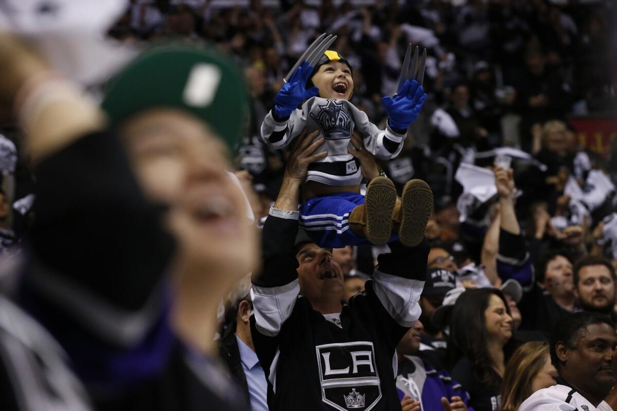 Kings fans celebrate following a goal by defenseman Drew Doughty during the second period of the team's 3-2 overtime win against the New York Rangers in Game 1 of the Stanley Cup Final.