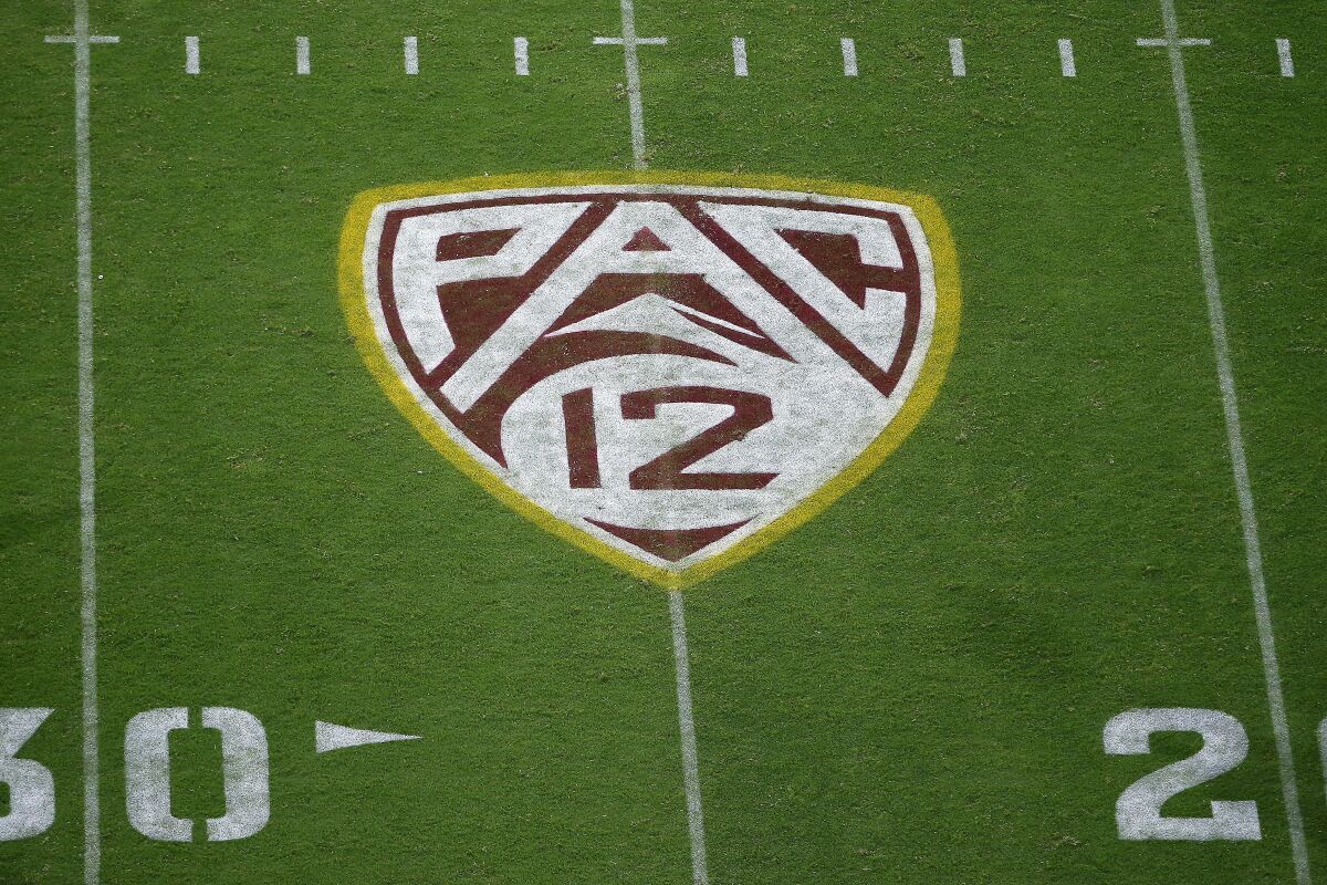 FILE - In this Aug. 29, 2019, file photo, the Pac-12 logo is displayed on the field at Sun Devil Stadium during an NCAA college football game between Arizona State and Kent State in Tempe, Ariz. As the wealthiest conferences like the Pac-12 lay out plans they hope will protect athletes from contracting and spreading COVID-19, most of the schools in the second-tier of Division I football have given up on trying to play in the fall. (AP Photo/Ralph Freso, File)