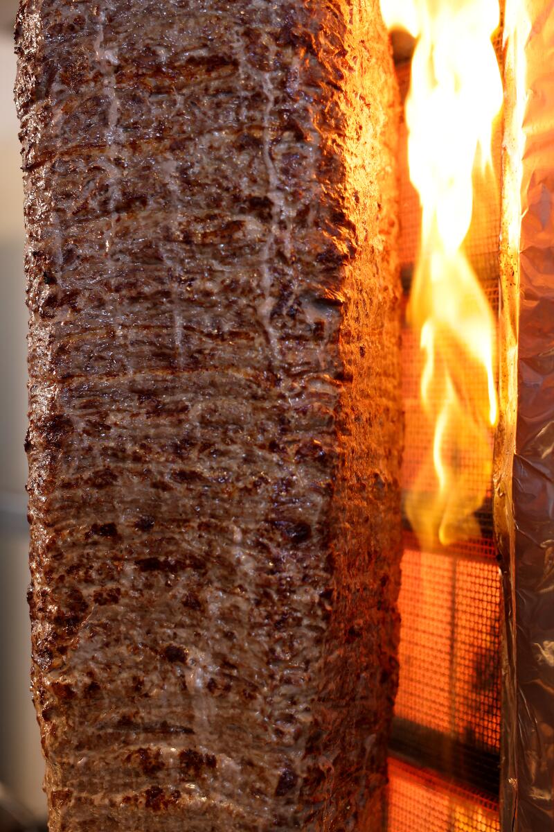 Pop-up doner kebab cooked on a vertical rotisserie.