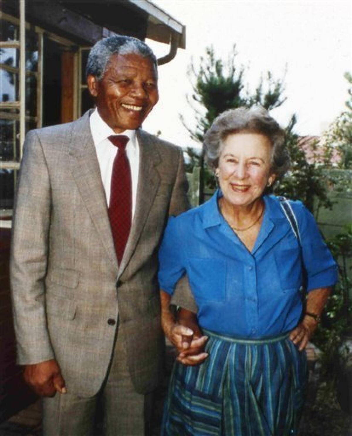 In this Feb. 26, 1990 file photo veteran anti-apartheid activist Helen Suzman, right, holds hands with Nelson Mandela, when Suzman visited Mandela at his Soweto, South Africa, home. The Nelson Mandela Foundation said Thursday, Jan. 1, 2009, that South African anti-apartheid activist Helen Suzman has died. She was 91. Foundation chief executive Achmat Dangor says Suzman was a "great patriot and a fearless fighter against apartheid." The cause of death was not immediately available Thursday. Suzman, who was white, was one of the few lawmakers who protested against white racist rule. She visited Mandela, the head of the then banned African National Congress, in prison in 1967 and became well-known for her campaigns against the injustices of apartheid. (AP Photo/John Parkin/file)