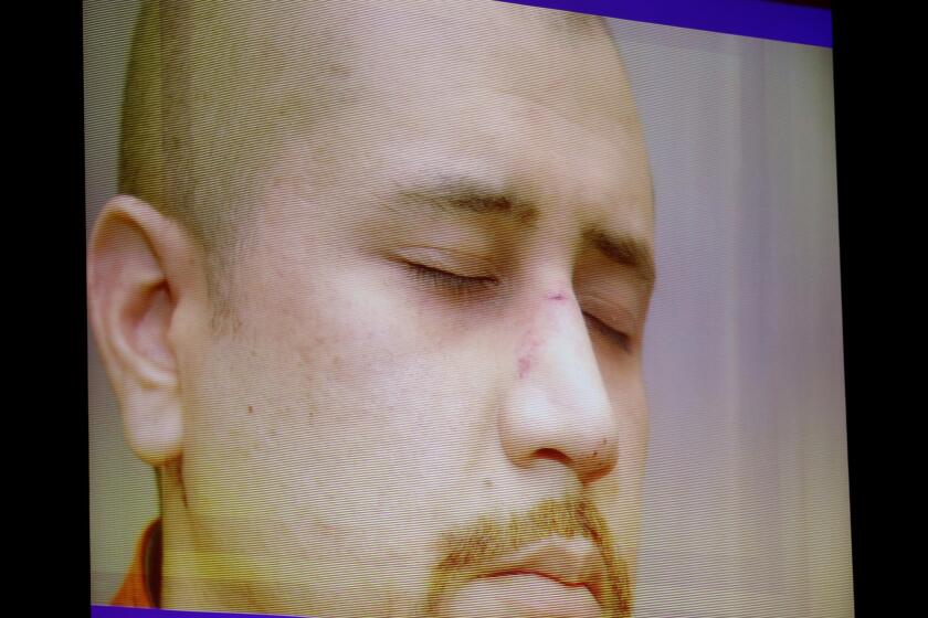 State exhibit photos, including this of George Zimmerman on the night of the Trayvon Martin shooting, are projected in court during the 15th day of Zimmerman's trial in Seminole circuit court, in Sanford, Fla., Friday, June 28, 2013. Zimmerman is accused in the fatal shooting of Trayvon Martin. (Joe Burbank/Orlando Sentinel/POOL) newsgate CCI B583027229Z.1