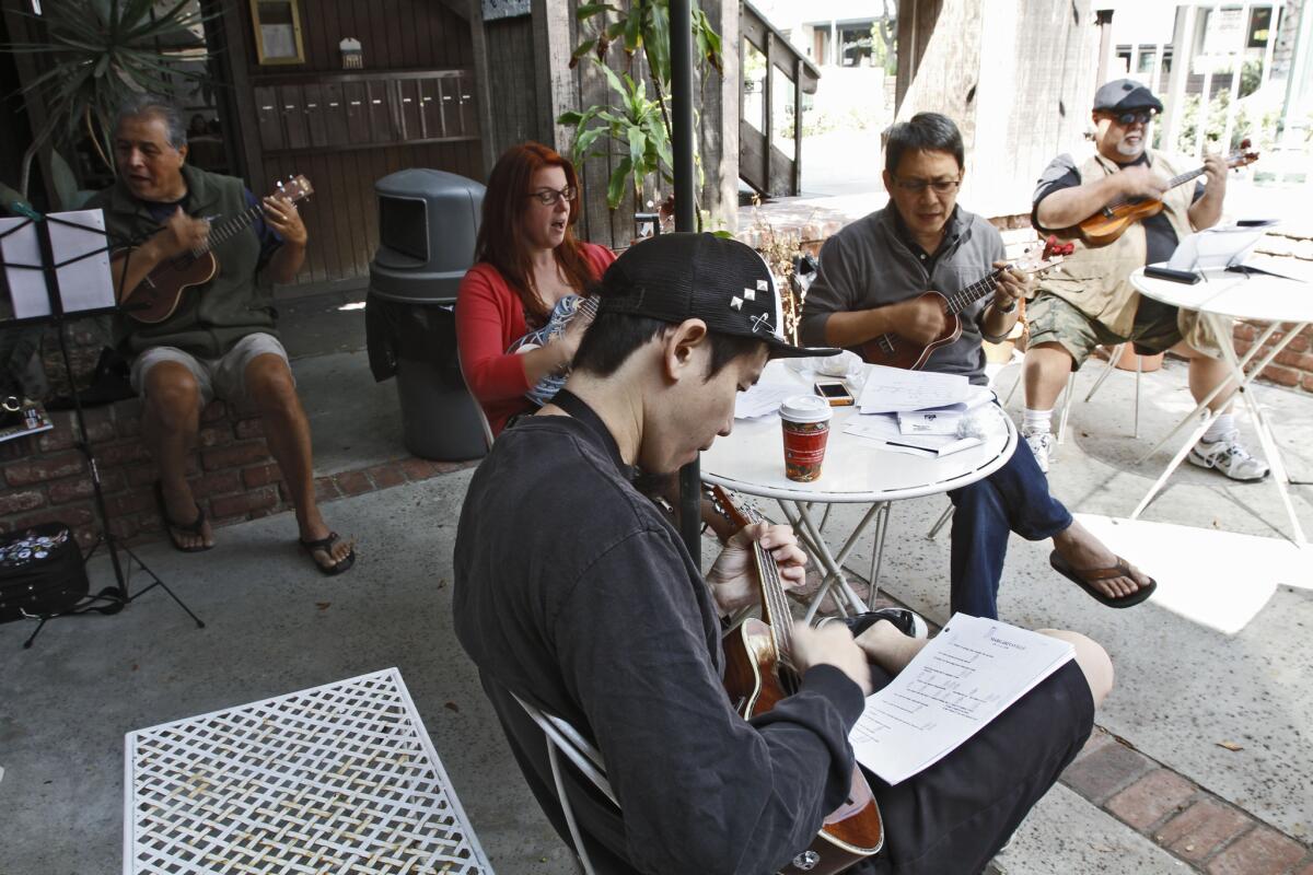 Beachcombers Kate's Ukes members play along to songs at Java Brew Coffee House, 2418 Honolulu Ave., in Montrose on Saturday, Sept. 21, 2013. Hiro Nakagawa of Alhambra is in the foreground.