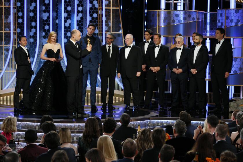 This image released by NBC shows Jesse Armstrong, third from left, and cast members accepting the award for best drama TV series for "Succession" at the 77th Annual Golden Globe Awards at the Beverly Hilton Hotel in Beverly Hills, Calif., on Sunday, Jan. 5, 2020. (Paul Drinkwater/NBC via AP)