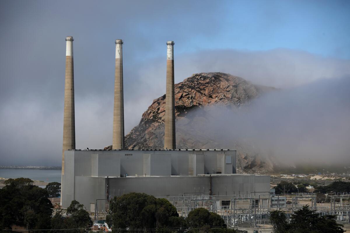 Three smokestacks from a power plant.