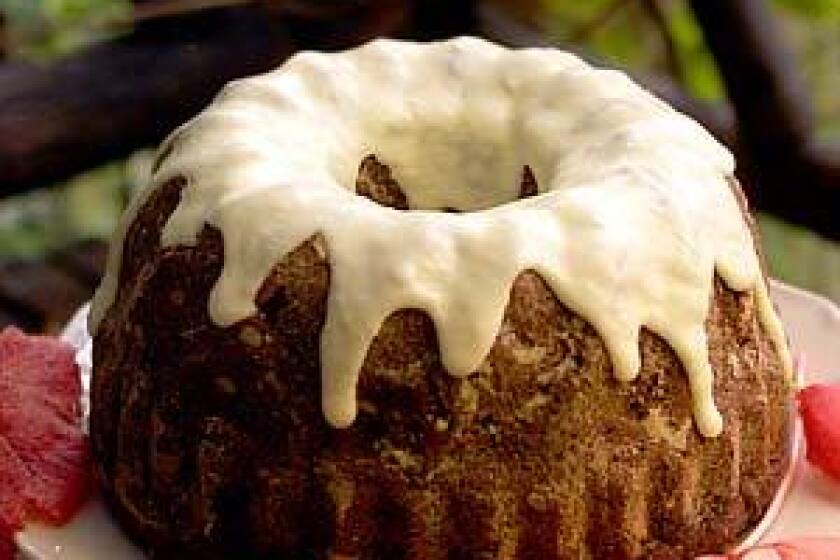 A thick rum orange icing tops persimmon cake, an inspired dessert for the fall holiday table.