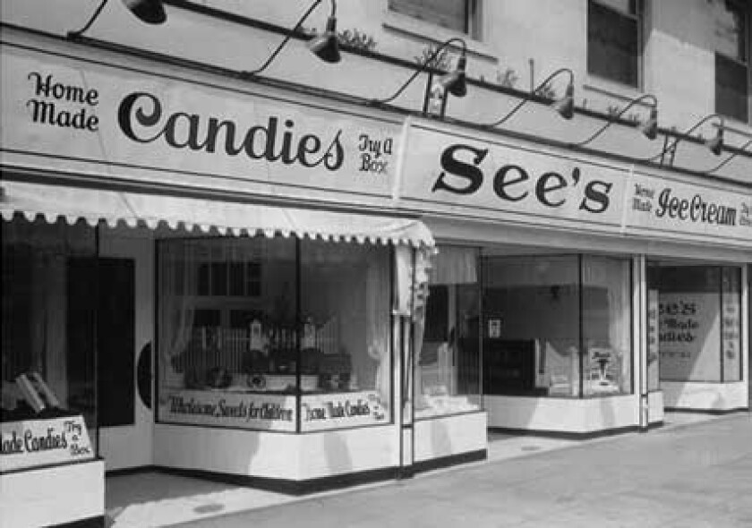A black and white photograph of See's Candies' first shop