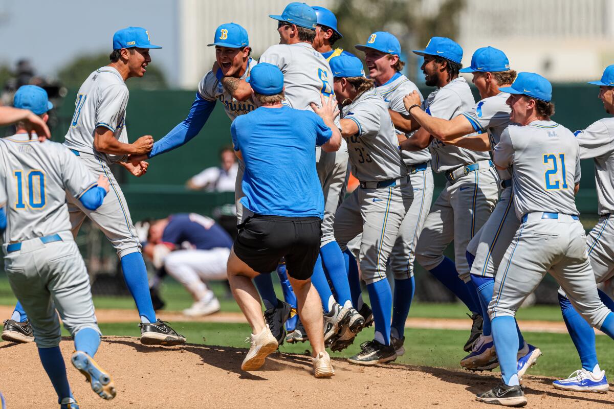 UCLA players celebrate after beating Texas San Antonio to advance to the College World Series.