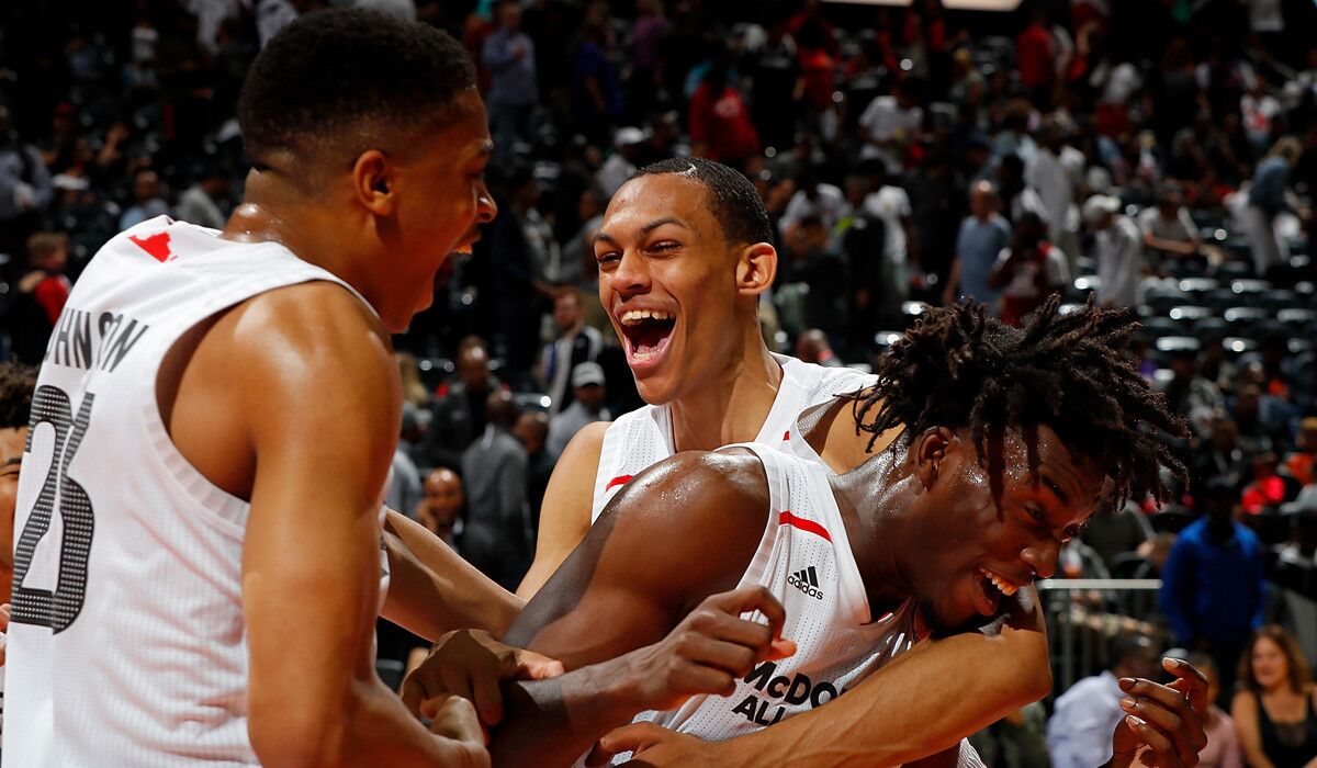 Nassir Little is congratulated by teammates Keldon Johnson, left, and Darius Bazley during the 2018 McDonald's All-American game.