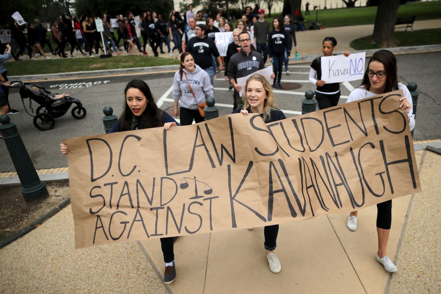 Demonstrators from Washington-area law schools -- including Georgetown, George Washington, Howard, the District of Columbia and Catholic universities -- march on the U.S. Capitol East Lawn to protest the Kavanaugh confirmation.