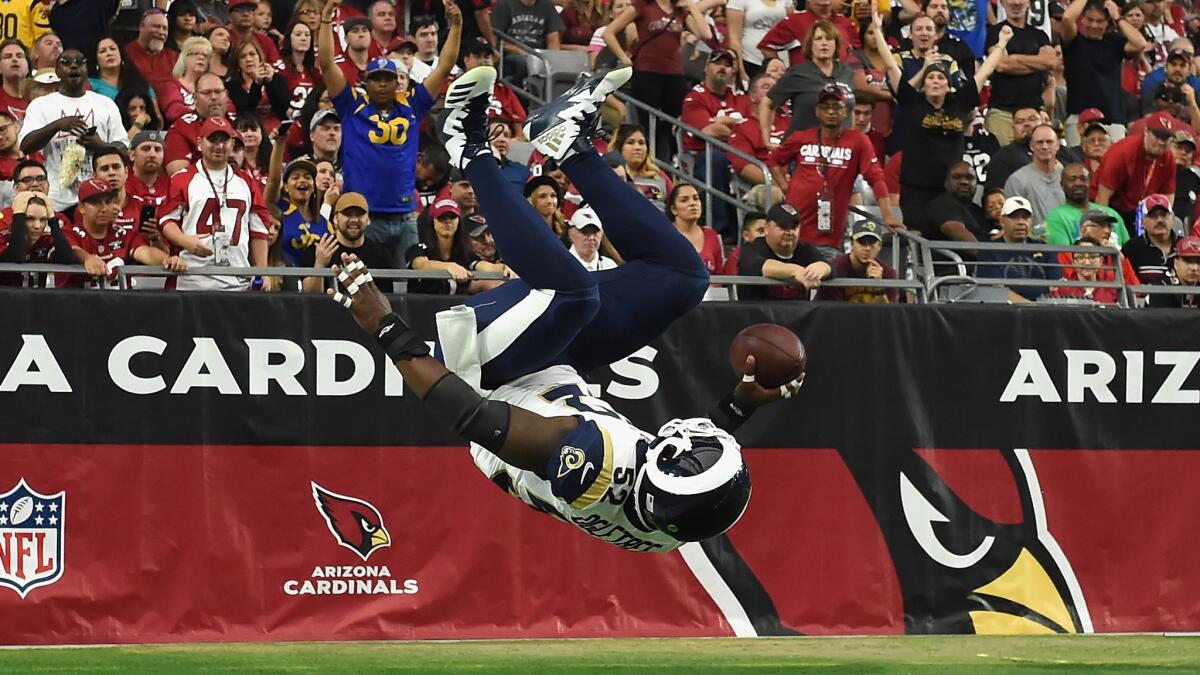 Inside linebacker Alec Ogletree of the Rams flips into the end zone during a 41-yard interception return for a touchdown in the first quarter.