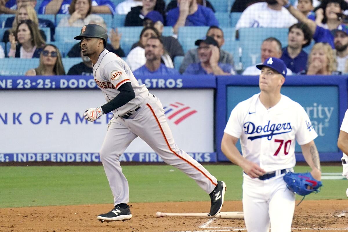 The Giants' LaMonte Wade Jr. heads out of the batter's box after hitting a three-run homer off Dodgers starter Bobby Miller.