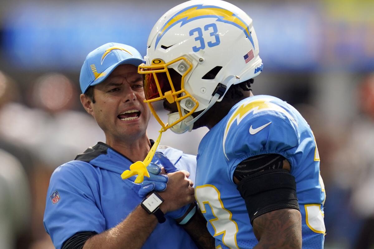 Chargers coach Brandon Staley talks to safety Derwin James before a win over the Cleveland Browns on Oct. 10.