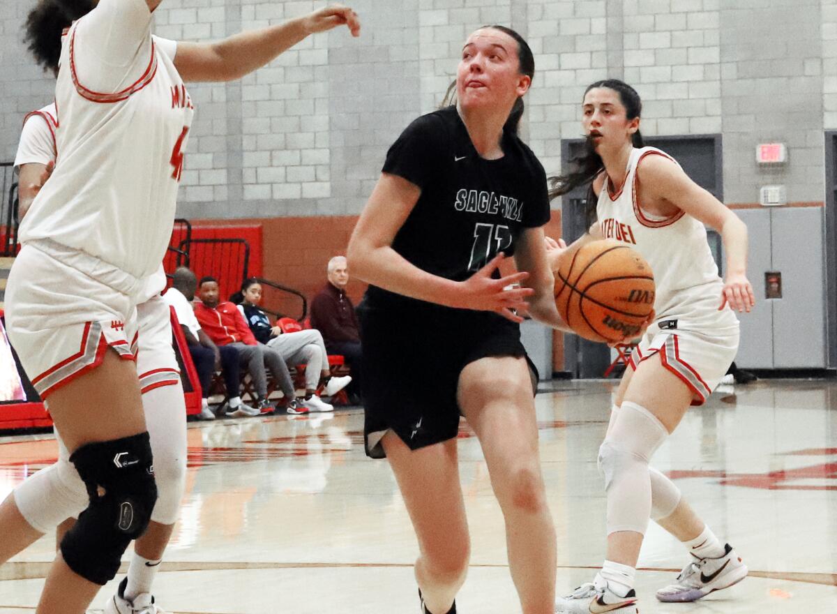 Sage Hill's Kat Righeimer (11) drives to the basket against Mater Dei on Wednesday, March 1.