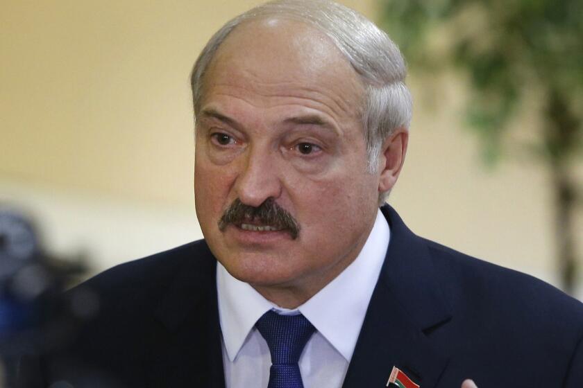 FILE - In this file photo taken on Sunday, Oct. 11, 2015, Belarusian President Alexander Lukashenko speaks to media at a polling station after voting during the presidential election in Minsk, Belarus. Alexander Lukashenko has appointed a new prime minister Saturday Aug. 18, 2018, and carried out a significant reshuffling of the government. (AP Photo/Sergei Grits, FILE)