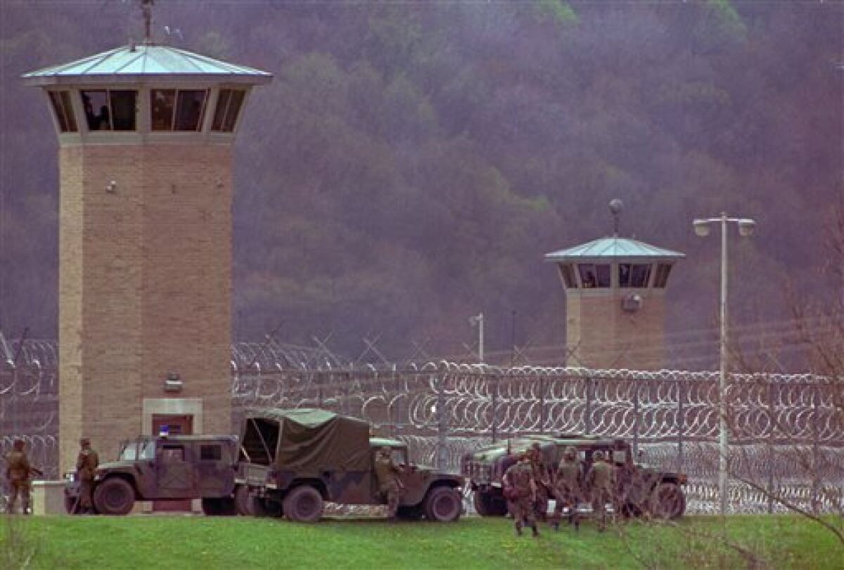 FILE - This April 28, 1993 file photo shows law officers and National Guard troops assembling outside the Southern Ohio Correctional Facility as a riot by inmates enters its 10th day in Lucasville, Ohio. In the 20 years since the nation's longest deadly prison riot broke out in Lucasville, no interviews have been granted with the five men sentenced to death in the killing of a guard. Yet time has brought new evidence and insights that will dominate events marking the 20th anniversary of the 11-d