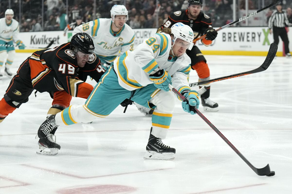 San Jose Sharks left wing Alexander Barabanov, right, moves the puck as Anaheim Ducks left wing Max Jones defends during the first period of an NHL hockey game Friday, Dec. 9, 2022, in Anaheim, Calif. (AP Photo/Mark J. Terrill)